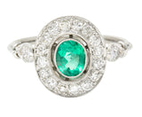 Vintage 1.07 CTW Oval Cut Emerald Diamond Platinum Foliate Halo Alternative Cluster Ring Wilson's Estate Jewelry