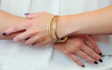 Four Vintage 14 Karat Yellow Gold Decorated Bangle Bracelets - Wilson's Estate Jewelry